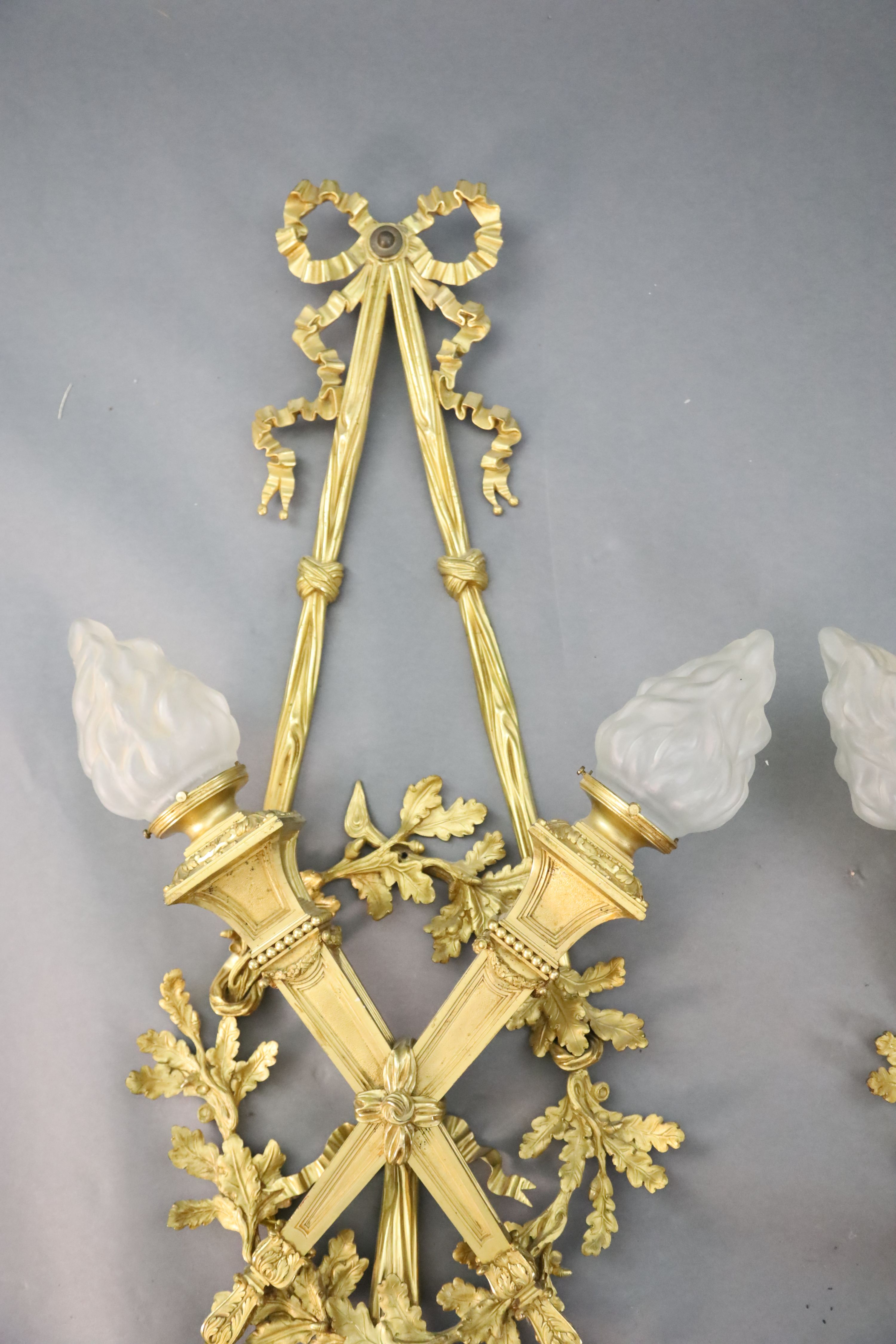 A pair of early 20th century Louis XVI style ormolu wall lights, width 1ft 10in. height 4ft 2in.